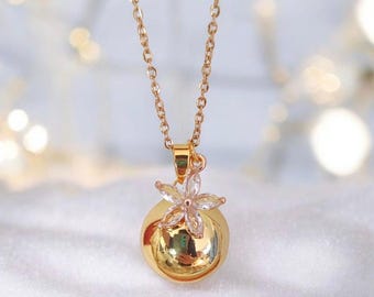 Gold pregnancy bola with rhinestone flower