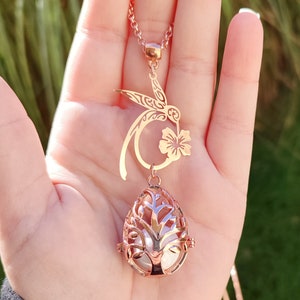 Rose gold hummingbird and hibiscus pregnancy bola. Fine jewelry.