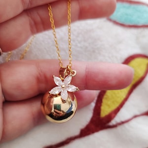 Golden pregnancy bola with rhinestone flower