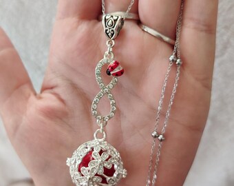 Infinity pregnancy bola and rhinestone ladybug. Stainless steel chain.