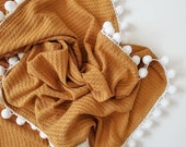 waffle knit pom pom swaddle blanket