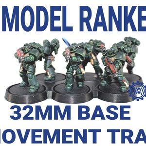 May include: Six green and black painted miniature figures on 32mm bases, arranged in a ranked formation on a black plastic movement tray. The tray has six circular slots for the bases. The text "6 MODEL RANKED 32MM BASE MOVEMENT TRAY" is printed in blue on a white background.