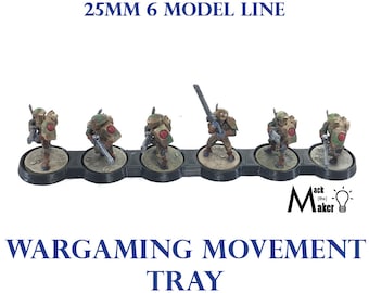 May include: A black plastic tray with six circular slots for holding miniature figures. The tray is designed for 25mm figures and is labeled "25MM 6 MODEL LINE WARGAMING MOVEMENT TRAY".