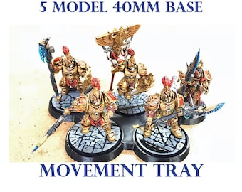 May include: Five gold and red painted miniature figures on 40mm bases, arranged on a black plastic movement tray. The tray has a stone-like texture. The text "5 MODEL 40MM BASE MOVEMENT TRAY" is printed on the image.