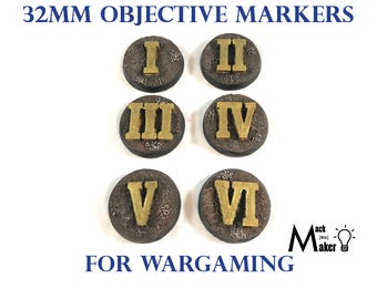 May include: Six 32mm round objective markers for wargaming. Each marker features a Roman numeral from I to VI in gold on a brown and gray textured surface.