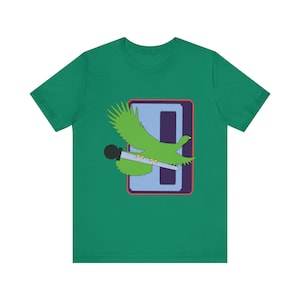 May include: Green t-shirt featuring a graphic of a green bird with a microphone, set against a blue and purple rectangular design. The bird is in flight, with its wings spread. The shirt is made of a soft material.