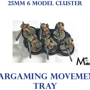 May include: A 25mm 6 model cluster wargaming movement tray with six painted miniatures. The tray is black and has six circular slots for the miniatures. The miniatures are painted in camouflage colors with red accents.