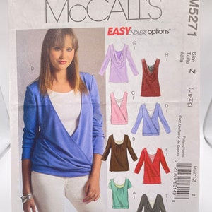 May include: Sewing pattern for a women's top with a variety of neckline options. The pattern includes instructions for making a cowl neck, a scoop neck, a V-neck, and a scoop neck with a ruffle. The pattern is for sizes Large to Extra Large. The pattern number is M5271.
