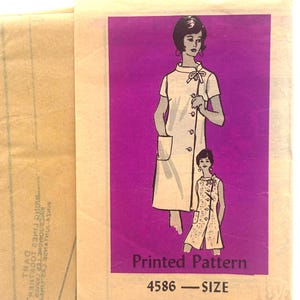 May include: A vintage sewing pattern envelope featuring a bright purple rectangular graphic with two illustrations of a dress with a high collar, side buttons, and a pocket. The text reads Printed Pattern 4586 - SIZE 18 1/2 on the front.
