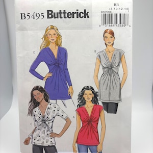 May include: A Butterick sewing pattern envelope, B5495, featuring illustrations of women's tops. The envelope displays a variety of top styles in different colors and patterns, including a long-sleeved purple top and a red short-sleeved top.