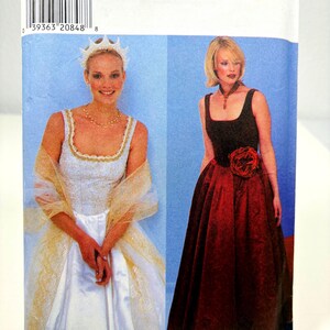May include: A sewing pattern for two dresses, one white with a sheer overlay and a crown, and one red with a flower accent. The pattern number is 2873, size A, 6-16, EUR 32-42.