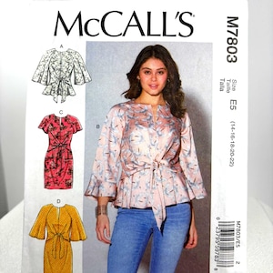 May include: McCall's M7803 sewing pattern envelope featuring illustrations of four garment variations including a tie-front top and dresses with flutter sleeves. The cover displays a model wearing a light pink floral tie-front top with blue jeans.