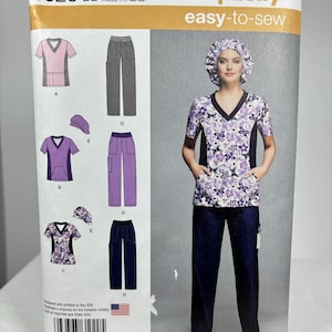 May include: Simplicity sewing pattern 1020 BB easy-to-sew for sizes 20W-28W. The pattern includes instructions for making scrubs with a V-neck top, pants, and a scrub cap. The pattern is printed on white paper with a yellow border and features a model wearing the scrubs in a floral print.