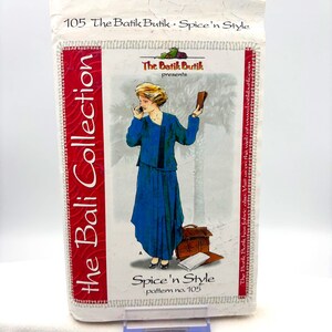 May include: A sewing pattern envelope titled 105 The Batik Butik Spice'n Style The Bali Collection. The front features an illustration of a person in a blue jacket and skirt, holding a phone and a wallet, with a brown briefcase and papers nearby.