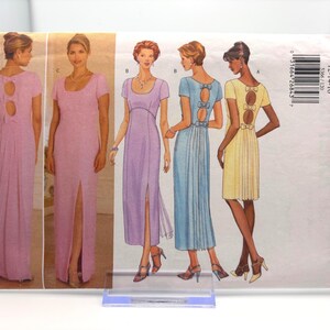 May include: A sewing pattern featuring illustrations of women's dresses in various colors, including pink, lavender, blue, and yellow. The dresses have different necklines, sleeves, and back details. The pattern is labeled "5366 Butterick classics".