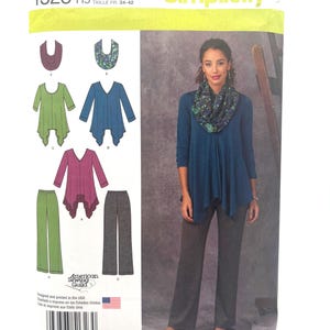 May include: Simplicity pattern 1323 features a woman wearing a teal top and gray pants. The pattern includes designs for tops and pants. The pattern size is US 6,8,10,12,14. The pattern is printed in the USA.