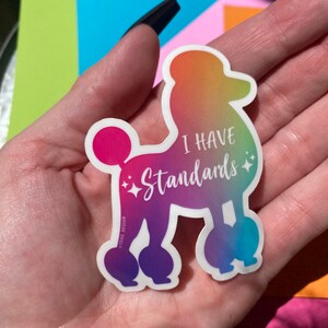 May include: A rainbow gradient sticker of a poodle with the text "I have standards" and sparkles.