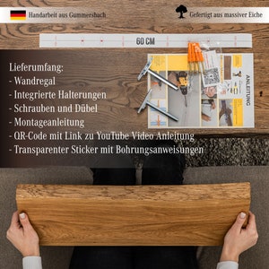 May include: A wooden shelf with a 60-inch length, made from solid oak. The shelf comes with mounting brackets, screws, and a QR code for a YouTube video instruction. The shelf is handcrafted in Gummersbach, Germany.