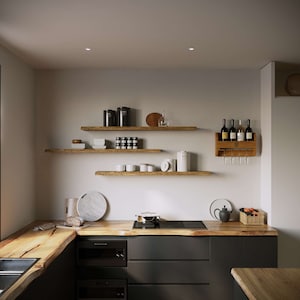 May include: A modern kitchen with dark gray cabinets and a wooden countertop. The kitchen features a wooden wine rack with wine bottles, wooden shelves with various items, and a black stovetop.