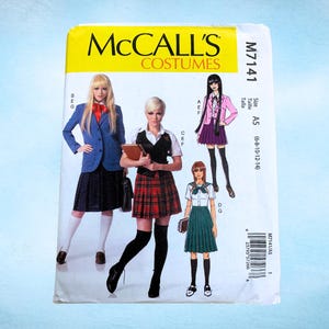 May include: A McCall's Costumes sewing pattern, M7141, featuring illustrations of school uniform costume designs. The pattern includes sizes A5 (6-8-10-12-14). The cover is yellow with the McCall's logo and costume illustrations.