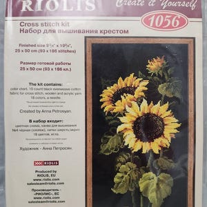 May include: A Riolis 1056 cross stitch kit featuring a sunflower design on a black background. The packaging displays the finished size as 9 3/4 inches by 19 3/4 inches, 25 by 50 cm, and lists contents including 10 count black evenweave cotton fabric.