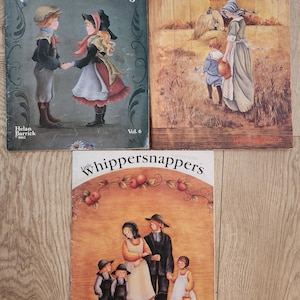 May include: Three vintage "whippersnappers" books by Helan Barrick. The covers feature illustrations of children and families in a rustic style. Volume 6 shows children holding hands, and Volume 7 depicts a family. The books are from 1982.