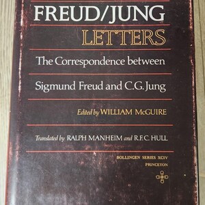May include: A vintage book titled "The Freud/Jung Letters" with a dark brown cover. The title and author names are in white and gold lettering. The book is edited by William McGuire and translated by Ralph Manheim and R.F.C. Hull.