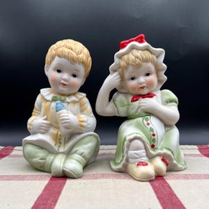 Set of 2 Vintage Porcelain Boy and Girl Piano Baby Bisque Figurines