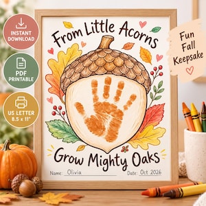 May include: A framed print featuring a large acorn illustration with a central orange handprint. The text reads From Little Acorns Grow Mighty Oaks, with lines for Name and Date. The design includes colorful autumn leaves, berries, and small hearts.