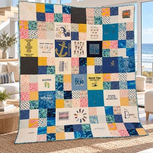 May include: A patchwork quilt constructed from various fabric squares featuring blue, yellow, and pink patterns. The quilt displays multiple graphic prints, including an anchor, flip-flops, and text such as Beach Time, Beach Bound, and Having a whale of a time.