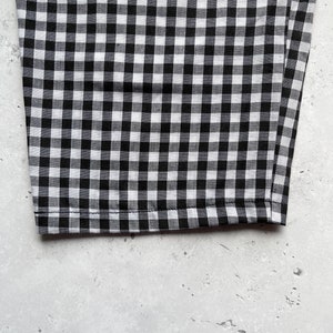 Black and white gingham print tapered leg trousers close up