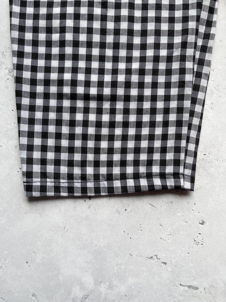 Black and white gingham print tapered leg trousers close up