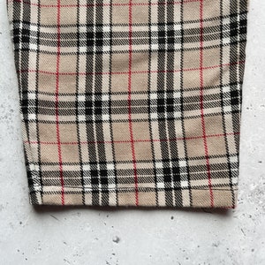 Beige nova check tartan tapered leg trousers close up