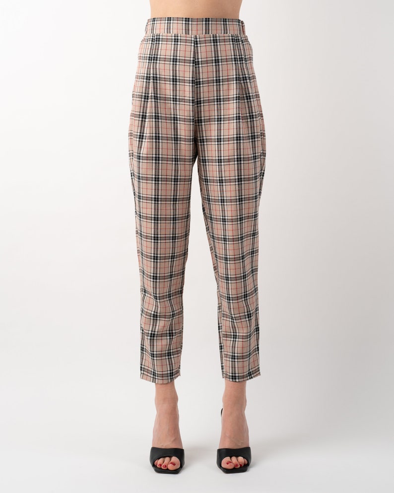 Beige nova check tartan tapered leg trousers front