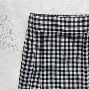 Black and white gingham print tapered leg trousers front close up