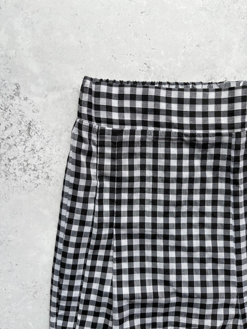 Black and white gingham print tapered leg trousers front close up