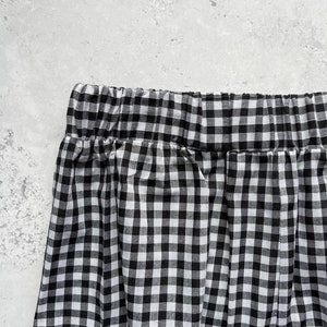 Black and white gingham print tapered leg trousers back close up