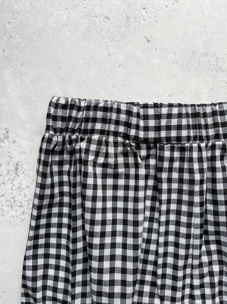 Black and white gingham print tapered leg trousers back close up