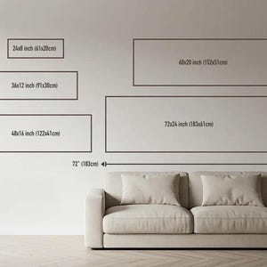 Size guide: this panoramic canvas next to a standard three seat sofa, with 12x36, 16x48, 20x60 and 24x72 inch outlines drawn to scale on the wall.