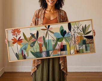 May include: A rectangular wall art piece in a light wood frame featuring a botanical illustration with stylized flowers and leaves in shades of orange, pink, blue, green, and black, set against a background of overlapping geometric color blocks.