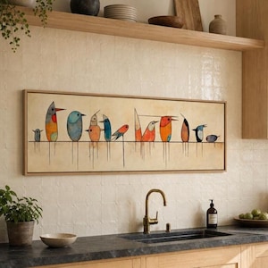 May include: A rectangular wall art piece in a light wood frame featuring a horizontal line with eleven stylized birds in various shapes and colors, including orange, blue, and grey, with thin vertical lines extending downward from each bird.