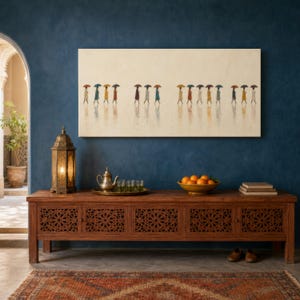 May include: A long wooden console table with intricate geometric lattice doors, topped with a brass lantern, a metal teapot, small glasses, and a bowl of oranges. Above, a large rectangular painting depicts figures walking with umbrellas.