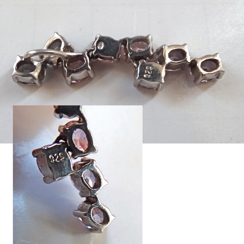 May include: A silver chain bracelet with a row of oval-shaped pink gemstones. The bracelet has a 925 stamp on one of the links.