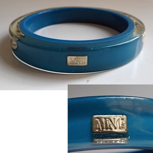 Pu&ograve; includere: Un braccialetto rigido blu turchese con un accento in metallo argentato e la parola "MNG" incisa sul davanti.