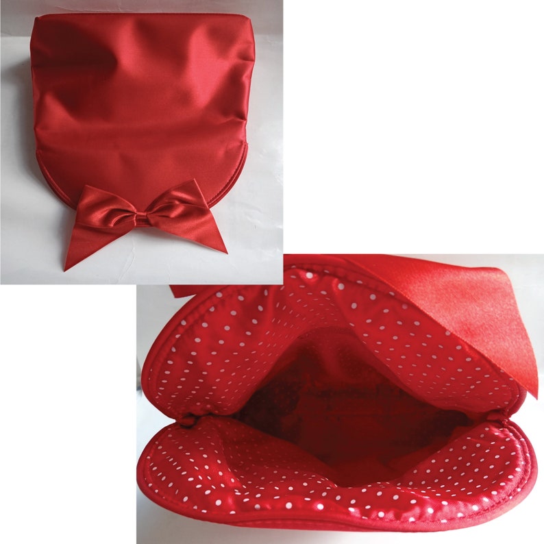 May include: A red satin clutch bag with a white polka dot lining. The bag has a large bow on the front.