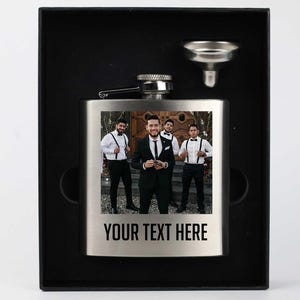 May include: A stainless steel flask with a personalized photo of four men in suits. The flask has a silver funnel and a black box. The text "YOUR TEXT HERE" is printed on the flask.