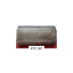 May include: A silver-colored, cylindrical object with two distinct textured patterns. One side features a honeycomb design, while the other showcases an intricate floral scrollwork. The text "ETC 107" is printed on the image. This item could be a decorative roller or a similar craft tool.
