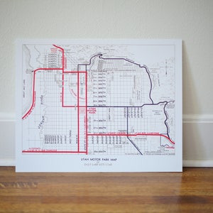 May include: A black and white map of Salt Lake City, Utah, with red and blue lines highlighting the Utah Motor Park. The map shows the city's streets and landmarks, including the Jordan River and the Great Salt Lake.