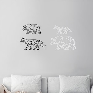 May include: Four geometric wall art pieces featuring animal silhouettes. There is a black bear and a black fox on the left, and a white fox and a white bear on the right. Each animal is constructed from a series of connected straight lines.
