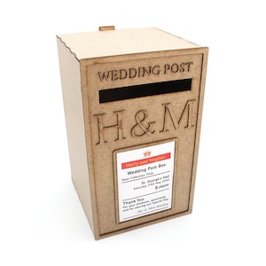 May include: A wooden wedding post box with the text "WEDDING POST" and "H&M" carved into the front. A rectangular slot is cut into the top for cards. A label on the front reads "Harry and Meghan Wedding Post Box".